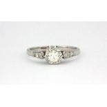 An 18ct white gold (stamped 18ct) diamond set solitaire ring with diamond set shoulders, approx. 0.