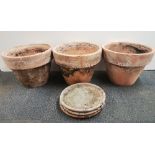 Three very large terracotta plant pots and saucers, Dia. 58cm, H. 44cm.