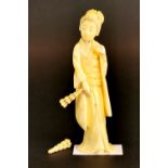 A 19th century Japanese carved ivory figure holding dancing fans (one detached). H. 11cm.