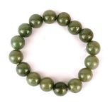 A single strand bracelet of carved polished jade beads (dia. 13mm).