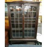 An Arts and Crafts leaded oak bookcase, W. 100cm, H. 157cm.