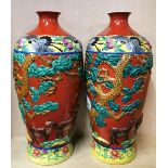 A pair of large 20th Century Chinese relief decorated and hand painted porcelain vases, H. 58cm.