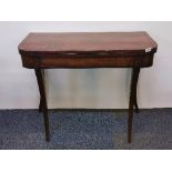 A regency mahogany folding tea table with reeded sabre legs, W. 91cm. H. 74cm.