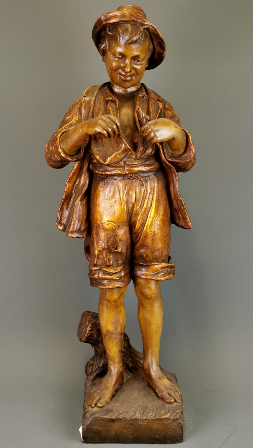 A large 19th Century ceramic figure of a boy fishing. H. 75cm. Repair to neck and feet.