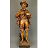 A large 19th Century ceramic figure of a boy fishing. H. 75cm. Repair to neck and feet.