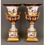 A pair of continental chinoiserie decorated and gilt porcelain urns. H. 35cm.