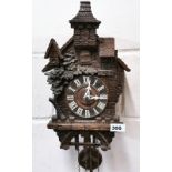 An early carved wooden Black Forest cuckoo clock, H. 54cm.