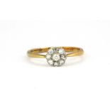 An 18ct gold and platinum (stamped 18ct & plat) diamond daisy cluster ring. (Q)