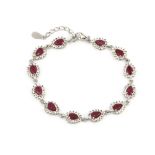 A 925 silver bracelet set with pear cut rubies and white stones, L. 18cm.