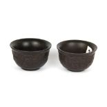 A pair of Chinese carved horn tea bowls, H. 5cm