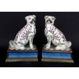 A pair of Chinese hand painted crackle glazed porcelain pug dog book ends, mounted on brass bases.
