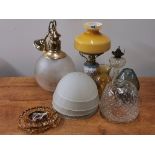 An oil lamp and a group of glass shades.