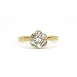 An 18ct yellow gold and platinum diamond set daisy cluster ring, (J).