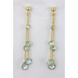 A pair of 925 silver gilt drop earrings set with faceted cut blue topaz, L. 7cm.