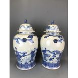 A pair of mid 20thC hand painted Chinese porcelain storage jars and lids, H. 50cm.