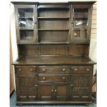 A large carved oak dresser, W. 155cm.