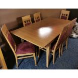 A contemporary extending dining table and six chairs, with maroon suede upholstery, table extends