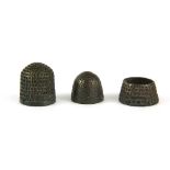 A 14th Century Medieval bronze beehive thimble, together with a similar period bronze tailor's