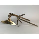 A small bronze display model of a patent 'CQR' single fluke plough anchor with hinged shank.