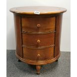An unusual circular teak chest of drawers, H. 60cm, Dia. 55cm.