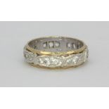 A 9ct white and yellow gold stone set eternity ring, (L), one stone missing.