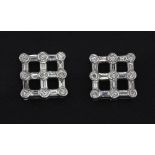 A pair of 18ct white gold (stamped 18K) diamond set stud earrings set with round and baguette cut