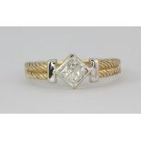 A hallmarked white and yellow 9ct gold ring set with four princess cut diamonds (Q.5)