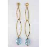 A pair of 18ct yellow gold (stamped 750) drop earrings set with blue topaz, with 9ct yellow gold