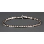 A heavy 18ct white gold diamond line bracelet set with 2ct+ of brilliant cut stones.