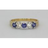 An 18ct yellow gold sapphire and diamond set ring, (M).