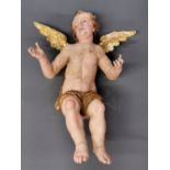 A large 18th Century carved wooden gesso finished painted and gilt figure of a seated cherub, H.