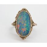 A rose metal ring (tested min 9ct gold)set with a large oval cut triplet opal, (M).
