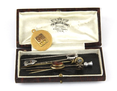 A box of stick pins, together with a Texaco yellow metal pendant.