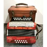 A cased Hohner Double-Ray piano accordion.