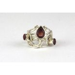 A white metal red stone set ring.