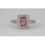 An 18ct white gold ring (stamped K18WG) set with a pink sapphire (.85ct) and diamonds (0.62ct) (M.
