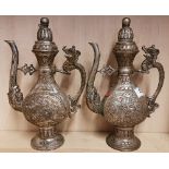 A pair of Chinese silvered bronzed wine ewers and lids with dragon and relief decoration, export