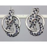 A pair of 925 silver snake shaped earrings set with sapphires and ruby eyes, L. 2.5cm.