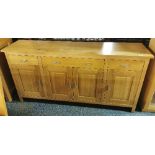 A contemporary solid oak sideboard with four drawers and four cupboards, W. 173cm, H. 86cm (slightly