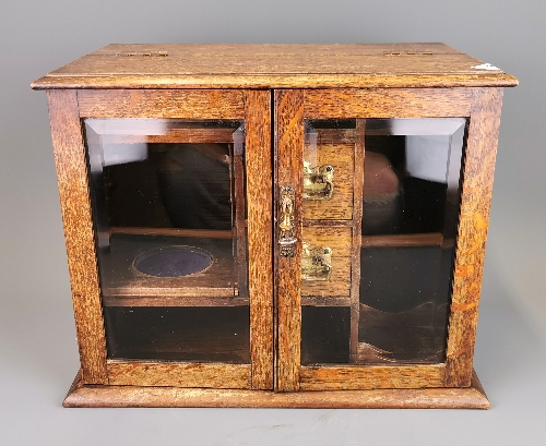 An early 20th Century oak smokers cabinet, H. 30cm.