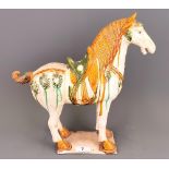 A Chinese glazed Tang Dynasty (618-907) style model of a horse, H. 35cm.
