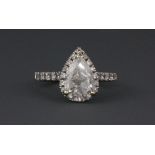 An 18ct white gold ring (stamped 750) set with a pear cut diamond just over 2ct weight surrounded by