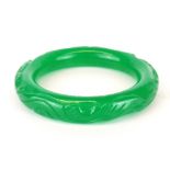 A Chinese carved green jade/ hardstone bangle, internal Dia. 6.2cm.