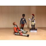 Three hand painted lead soldier figures, including one dressing a wound, H. 10cm.