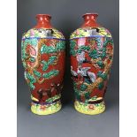 A pair of large 20th Century Chinese relief decorated and hand painted porcelain vases, H. 58cm.