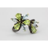 A 925 silver ring set with marquise cut blue topaz and pear cut peridots, (O.5).