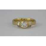 A heavy 18ct yellow gold (stamped 750) ring set with a very bright centre diamond, approx 0.48ct,