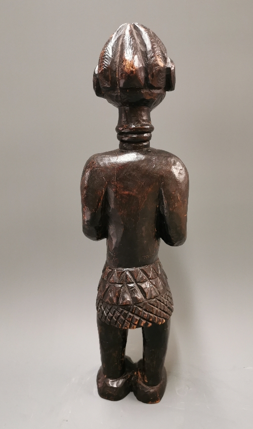 An African carved Punu Tribal fertility figure of a woman feeding a baby, H. 42cm.