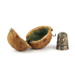 A Victorian walnut shell thimble case with a Hallmarked Silver thimble, size 3.5cm.