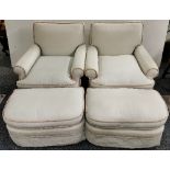 A pair of good quality upholstered armchairs with footstools.